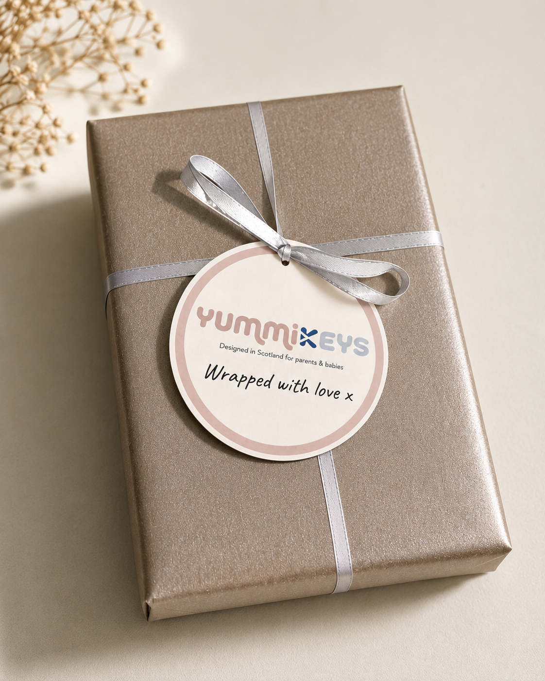 Silver kraft paper gift wrap with soft ribbon and signature logo seal in kraft gift box