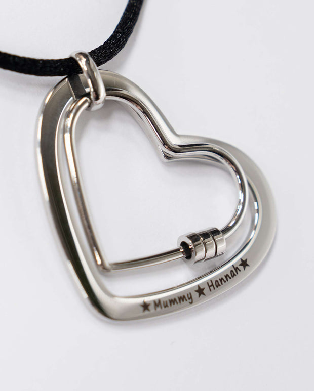 The Smooth Heart engraved stainless steel feeding necklace with smooth heart pendant on cotton cord for calming babies during feeding