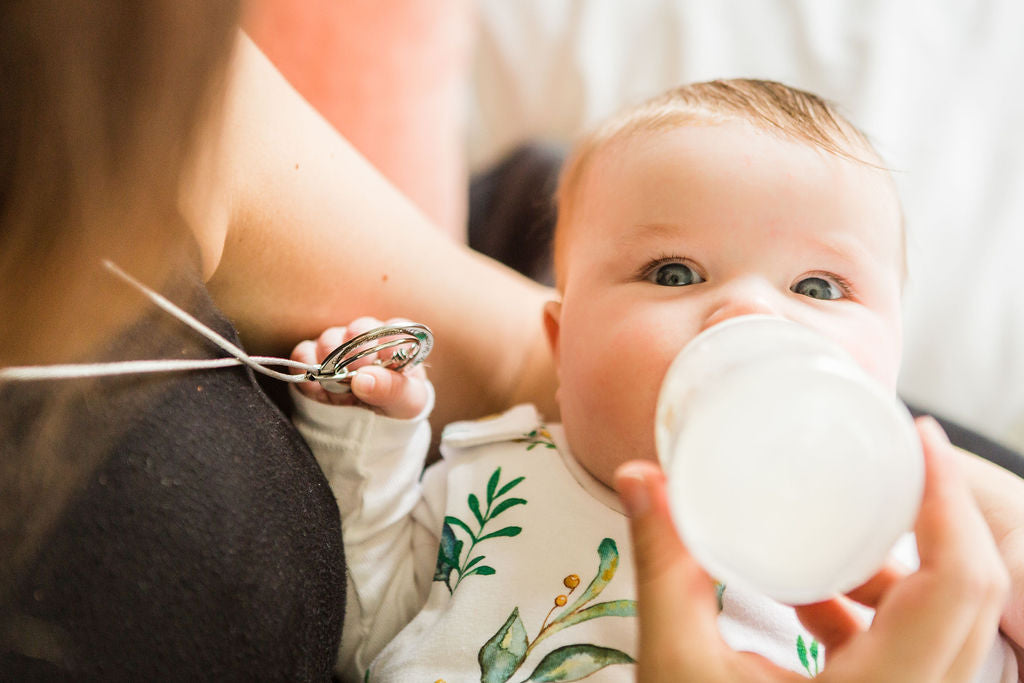 bottle feeding baby with feeding necklace