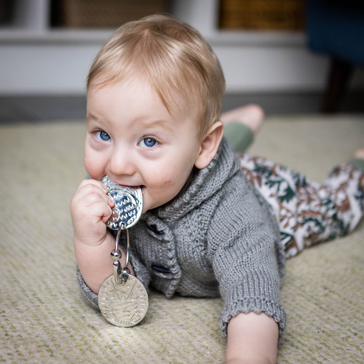 baby having tummy time and chewing yummikeys 